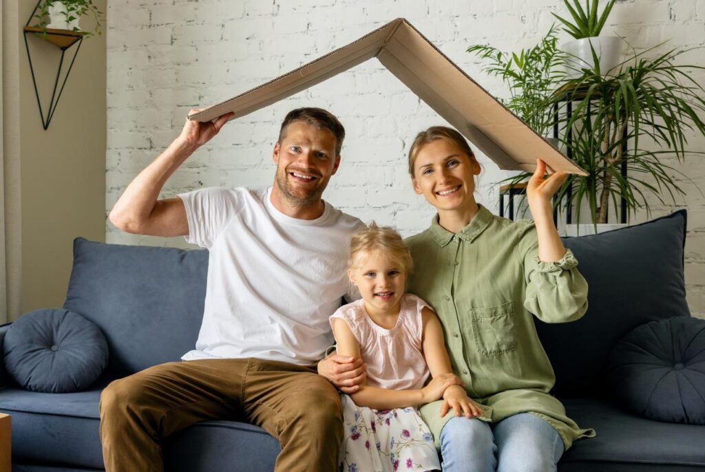 Happy Family with pretend roof overheads sitting on sofa