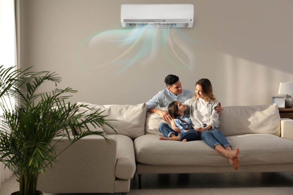 family comfortable on sofa with working AC wall unit